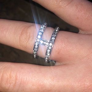 Silver ring size 7 with one side faux diamond and the other purple detail.